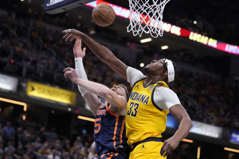 Indiana Pacers center Myles Turner (33) blocks a shot by New York Knicks center Isaiah Hartenstein (55) during the first half of Game 4 in an NBA basketball second-round playoff series, Sunday, May 12, 2024, in Indianapolis. (AP Photo/Michael Conroy)