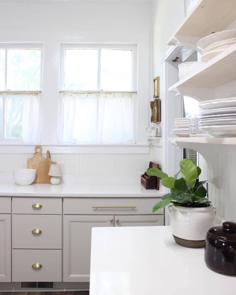 A remodeled kitchen with light gray cabinets.