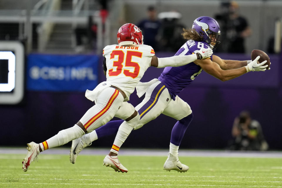 Minnesota Vikings tight end T.J. Hockenson (87) catches a pass in front of Kansas City Chiefs cornerback Jaylen Watson (35) during the second half of an NFL football game, Sunday, Oct. 8, 2023, in Minneapolis. The Chiefs won 27-20. (AP Photo/Abbie Parr)