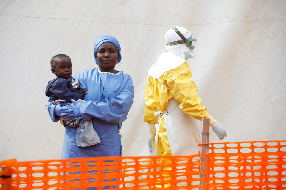 Mwamini Kahindo, an Ebola survivor working as a caregiver to babies who are confirmed Ebola cases, holds an infant outside the red zone at the Ebola treatment center in Butembo, Democratic Republic of Congo, March 25, 2019. (Photo: Baz Ratner/Reuters)