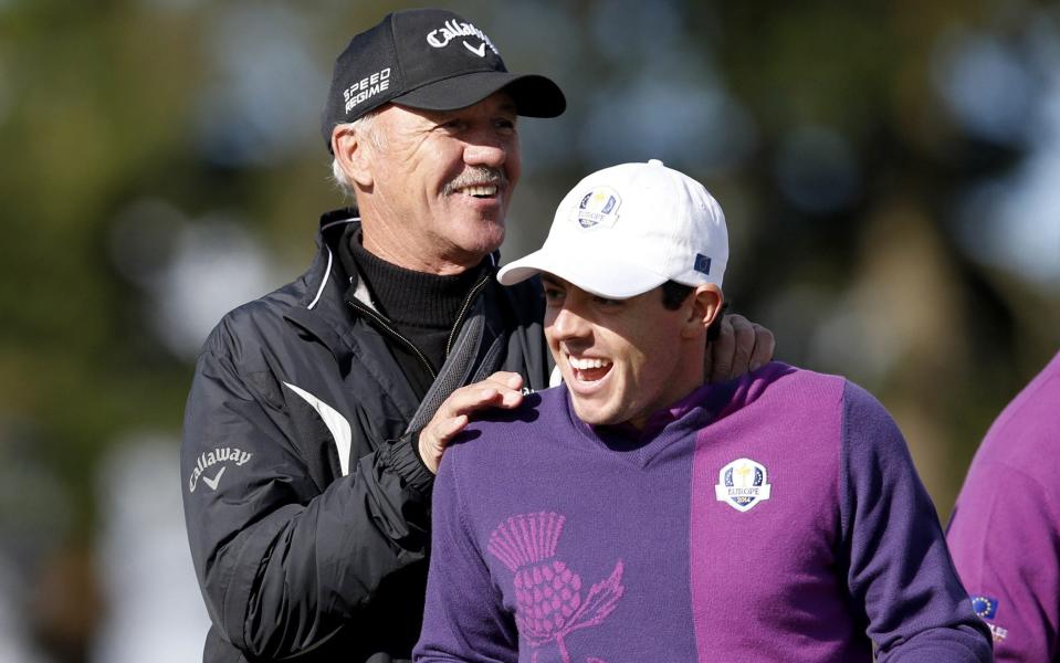Team Europe's Rory McIlroy of Northern Ireland shares a joke with coach Pete Cowen on the 10th hole during a practice round at the Gleneagles golf course in Gleneagles, Scotland, on September 24, 2014, - AFP