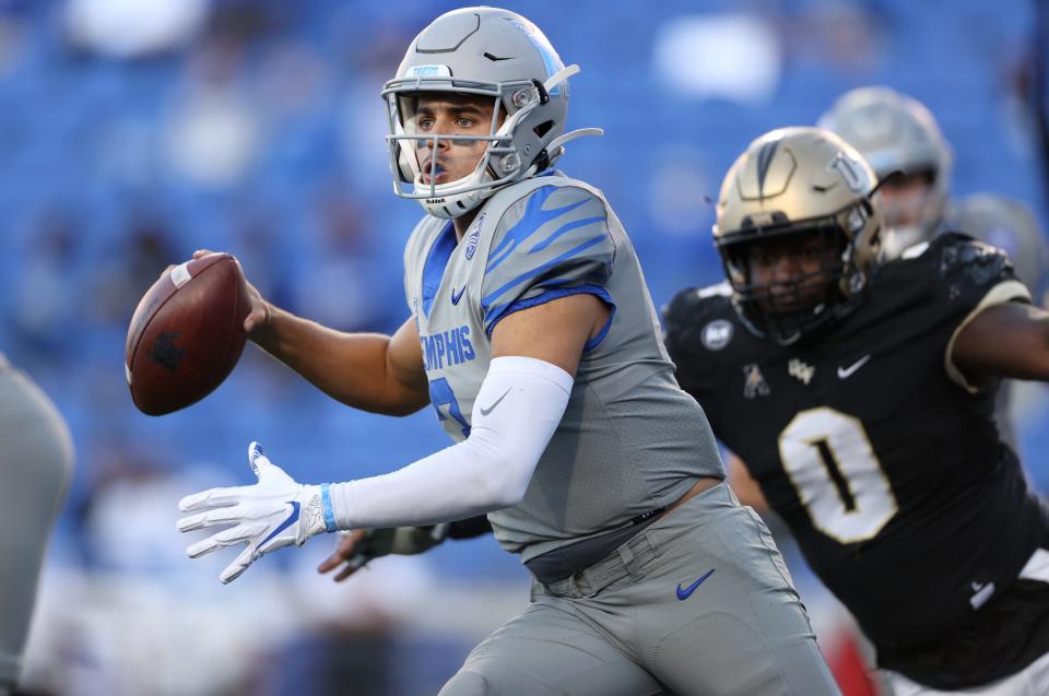 Memphis Tigers quarterback Brady White pump fakes in the pocket before scrambling for a first down against UCF during their game at Liberty Bowl Memorial Stadium on Saturday, Oct. 17, 2020. 