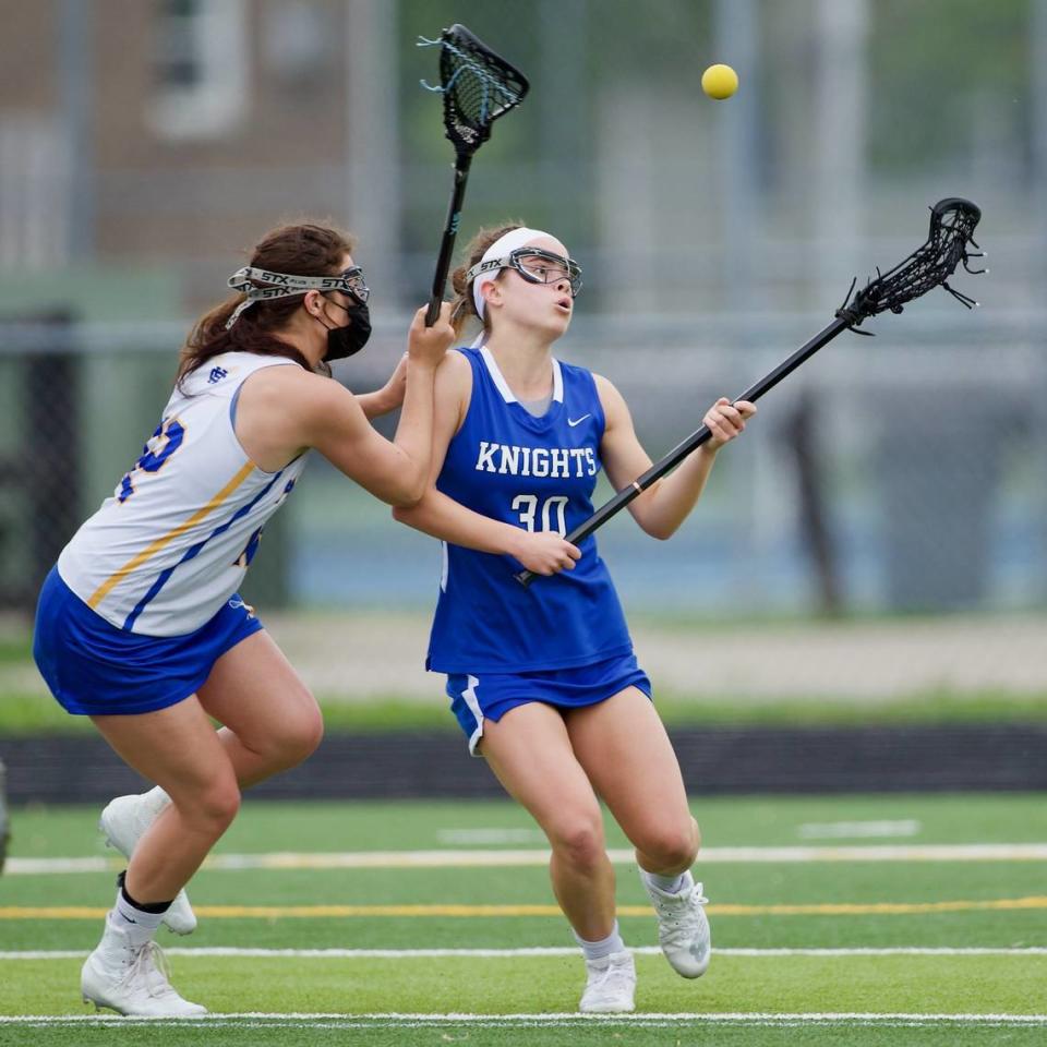 Lexington Catholic’s Morgan Cameron battles to cradle the ball against Henry Clay’s Tori Sloane during a May 2, 2021 game at Henry Clay. The boys’ and girls’ teams at Henry Clay each won the 2021 Commonwealth Lacrosse League state championship.