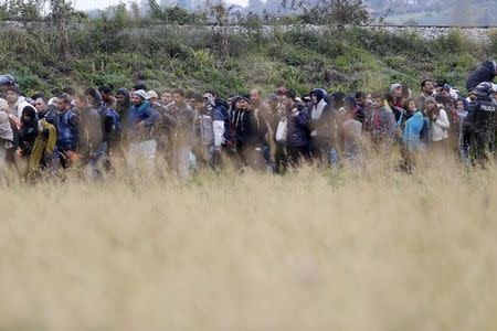 Migrants as they make their way on foot after crossing the Croatian-Slovenian border, in Rigonce, Slovenia, October 22, 2015. REUTERS/Srdjan Zivulovic