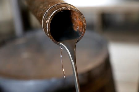 FILE PHOTO: Oil pours out of a spout from Edwin Drake's original 1859 well that launched the modern petroleum industry at the Drake Well Museum and Park in Titusville, Pennsylvania