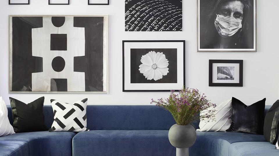 a room with a blue couch and a chandelier