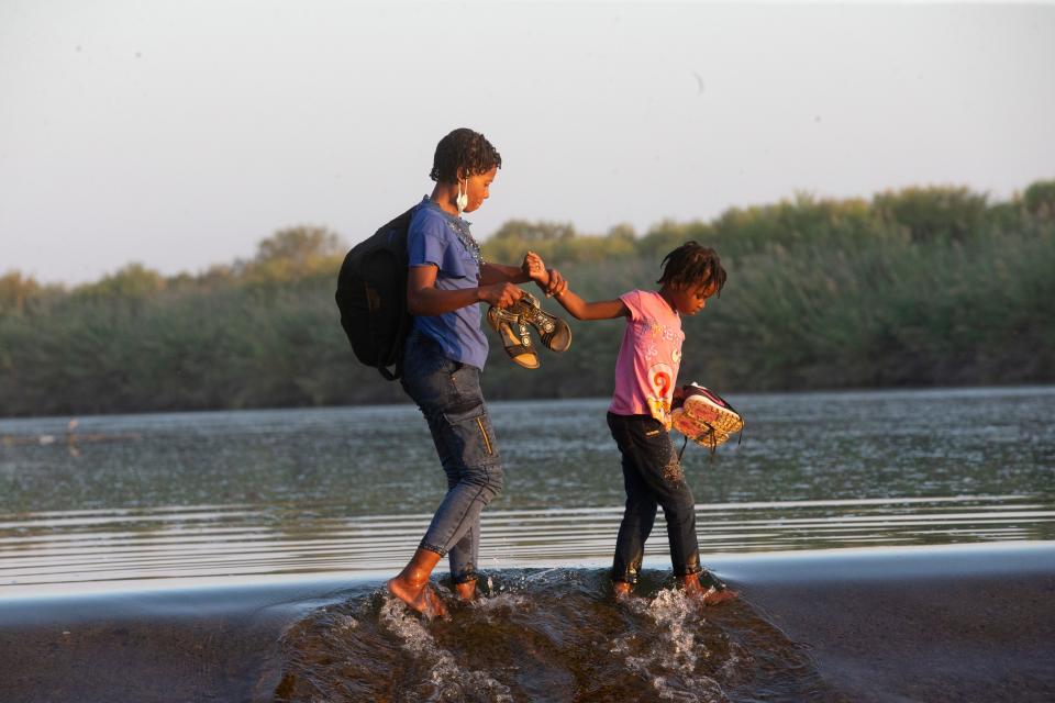 Haitian migrants cross the Rio Grande into Del Rio, Texas from Ciudad Acuna on September 18, 2021. Thousands of migrants have arrived in the border city and have camped underneath the Del Rio International Bridge on the U.S. side of the border.