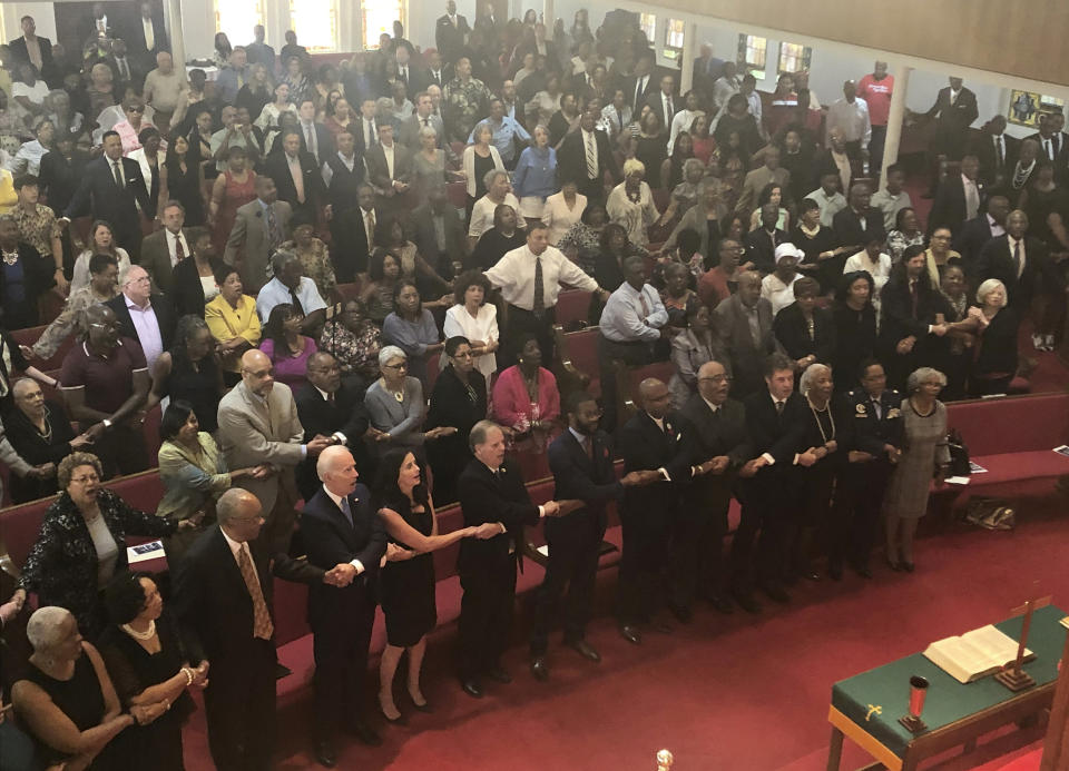 Presidential candidate and former Vice President Joe Biden, left front, joins the congregation of 16th Street Baptist Church in Birmingham, Alabama, as they sing “We Shall Overcome” at Sunday worship on Sept. 15, 2019. Biden was the keynote speaker as the congregation commemorated the 56th anniversary of the Ku Klux Klan bombing that killed four black girls in the congregation during the height of the civil rights movement. Biden is on the front pew along with Alabama Sen. Doug Jones, who as a federal prosecutor decades after the bombings prosecuted two of the responsible Klansmen, and Birmingham Mayor Randall Woodfin. (AP PhotoBill Barrow)