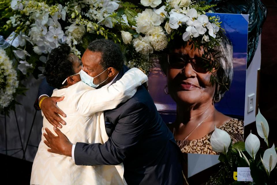 A mourner embraces Angela Crawley, left, daughter of Ruth Whitfield, a victim of the Buffalo supermarket shooting, before a memorial service at Mt. Olive Baptist Church with Vice President Kamala Harris in attendance, Saturday, May 28, 2022, in Buffalo, New York.