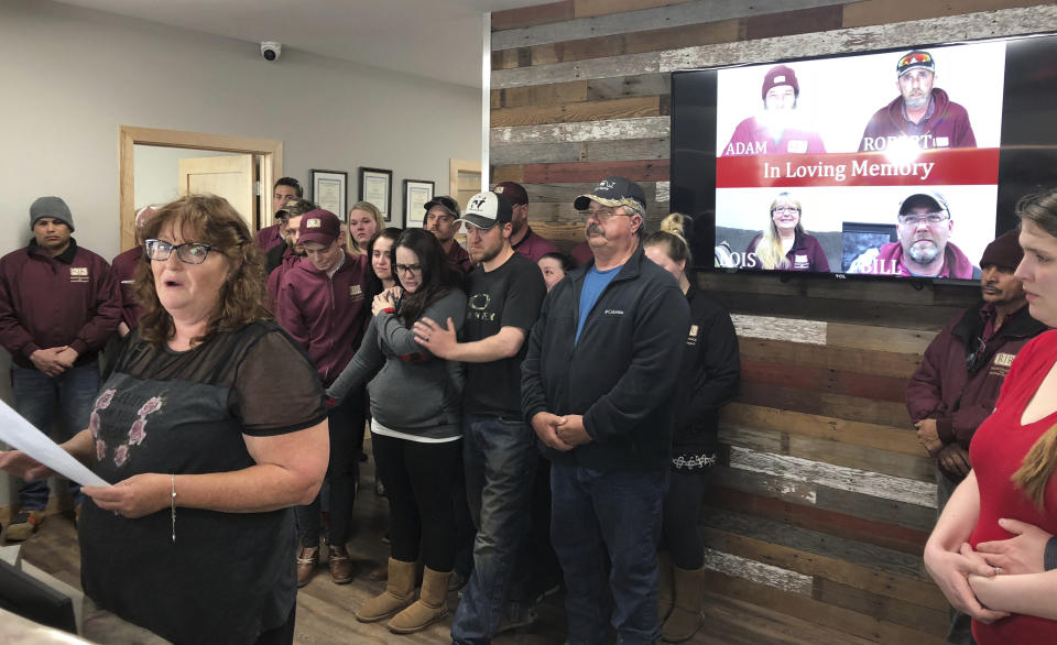 FILE - In this Friday, April 5, 2019, file photo, Jackie Fakler, co-owner of RJR Maintenance and Management, is surrounded by employees, in Mandan, N.D., as she reads a statement about the slayings of four RJR employees earlier this week in an attack at the company. The victims included her husband and co-owner, Robert Fakler. Jurors returned guilty verdicts Friday, Aug. 20, 2021 on all counts against Chad Isaak, who was charged in the deaths of RJR Maintenance & Management co-owner Robert Fakler and employees Adam Fuehrer, William Cobb and Lois Cobb in April 2019. (AP Photo/James MacPherson, File)