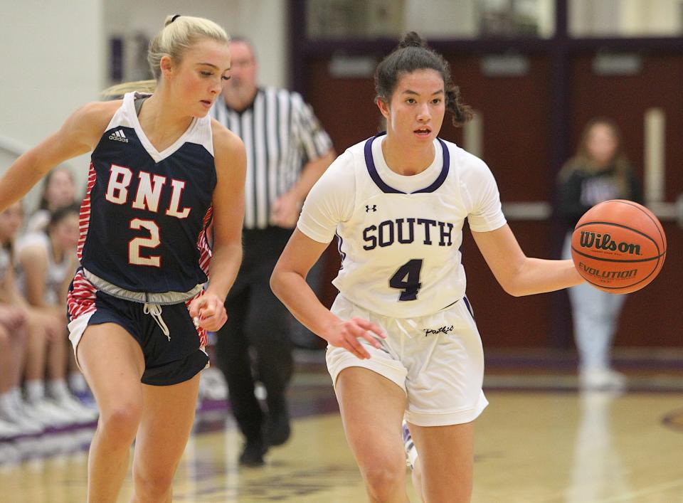 Bloomington South's Caitlin Heim (4) dribbles up court as Bedford North Lawrence's Chloe Spreen lurks nearby on defense in their girls' basketball game on Tuesday, Nov. 15, 2022.