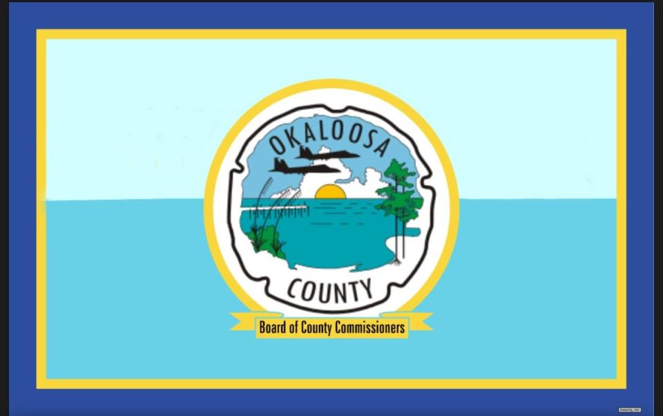 The proposed update to the flag would see the removal of the dolphins and add the words "In God We Trust" in the ribbon head where "Board of County Commissioners" currently sits.