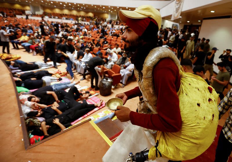 An Iraqi peddler sells juice as supporters of Iraqi Shi'ite cleric Muqtada al-Sadr gather during a sit-in, inside the parliament building amid political crises in Baghdad