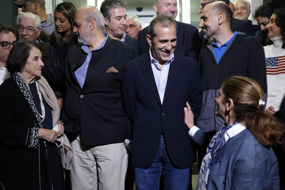 U.S officials arrange a group photo after freed Americans Siamak Namazi, Morad Tahbaz and Emad Shargi, as well as two returnees not yet named by the U.S. government, who were released in a prisoner swap deal between U.S and Iran, arrived at Davison Army Airfield, Tuesday, Sept. 19, 2023 at Fort Belvoir, Va. (Jonathan Ernst/Pool via AP)