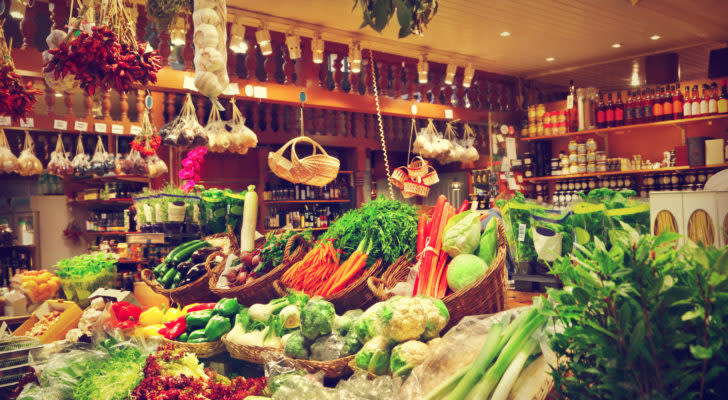 A photo of fresh and canned goods in a rustic grocery market display.