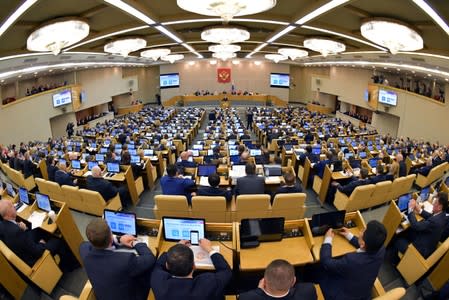 Members of Russia's lower house of parliament listen to Prime Minister Medvedev during a session of the State Duma in Moscow