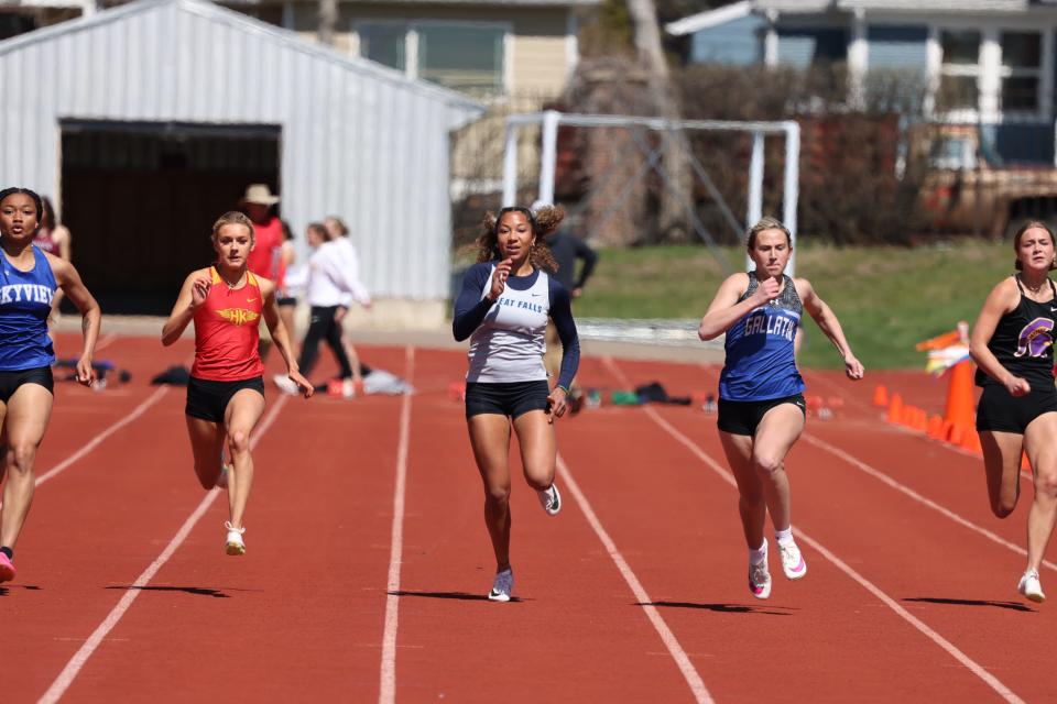 Great Falls High's Scarlet Harris, middle, competes in the 100-meter dash at the Optimist Meet earlier this season at Memorial Stadium.