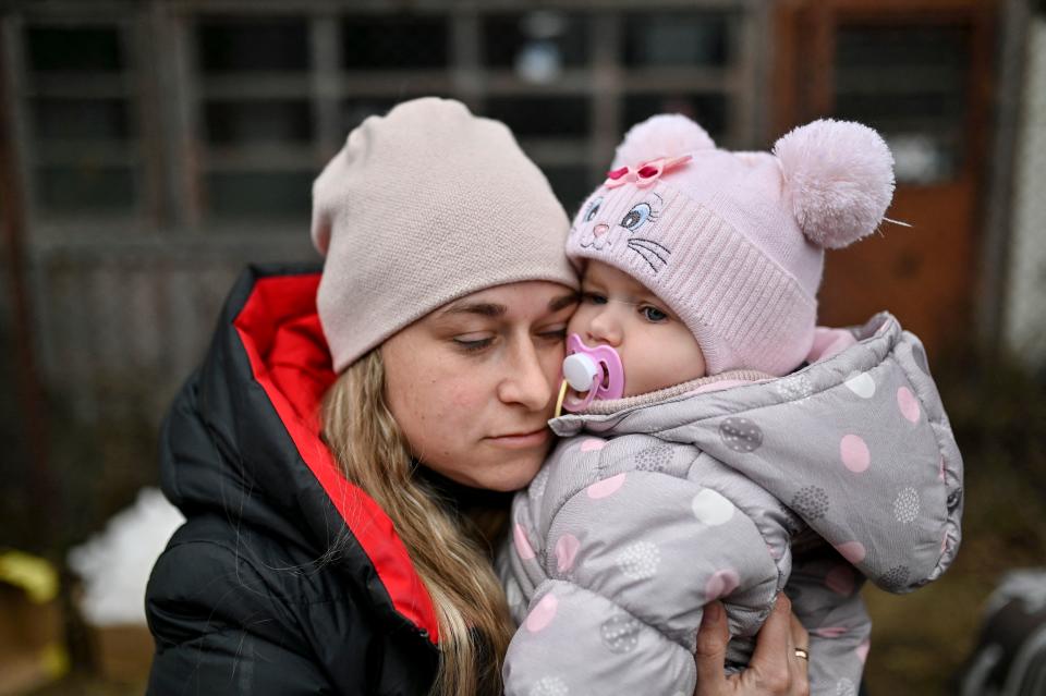 Marina Vizerska, evacuee from Ukraine, hugs her baby after they crossed the Ukrainian-Romanian border in Siret, northern Romania, on March 16, 2022. - More than three million people have fled Ukraine since the start of the invasion, the UN migration agency IOM says. Around half are minors, says the UN children's agency. (Photo by Armend NIMANI / AFP) (Photo by ARMEND NIMANI/AFP via Getty Images)