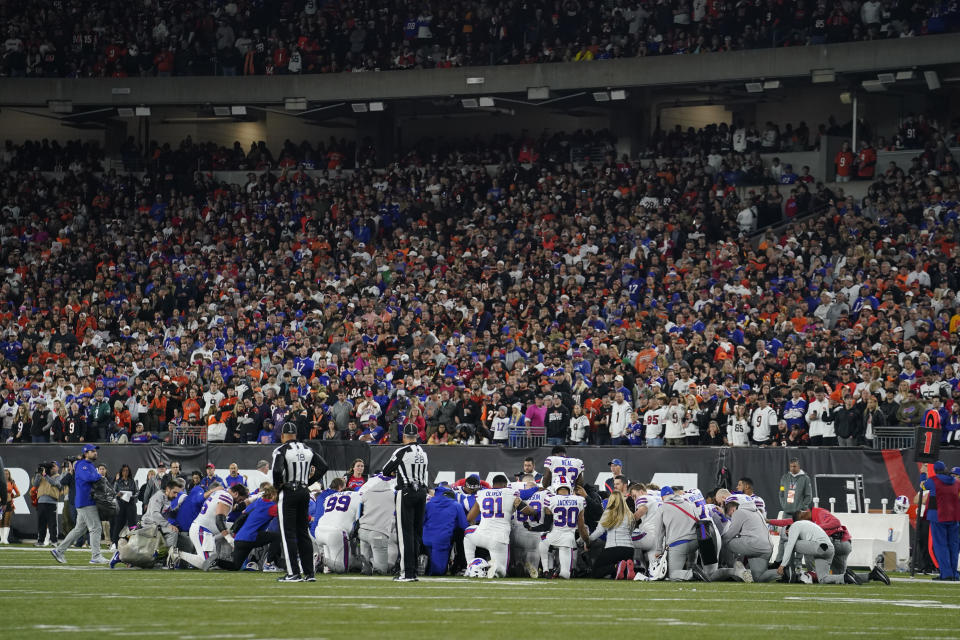 The Buffalo Bills players pray for teammate Damar Hamlin during the first half of an NFL football game against the Cincinnati Bengals, Monday, Jan. 2, 2023, in Cincinnati. (AP Photo/Jeff Dean)