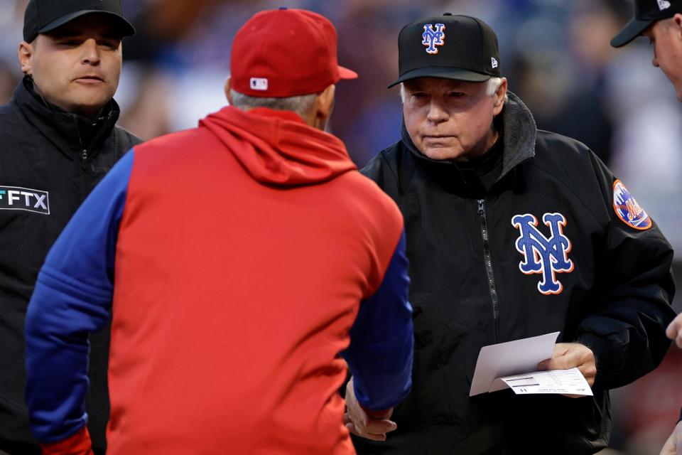 New York Mets manager Buck Showalter (11) shakes hands with Philadelphia Phillies manager Joe Girardi (25) before a baseball game on Friday, April 29, 2022, in New York.