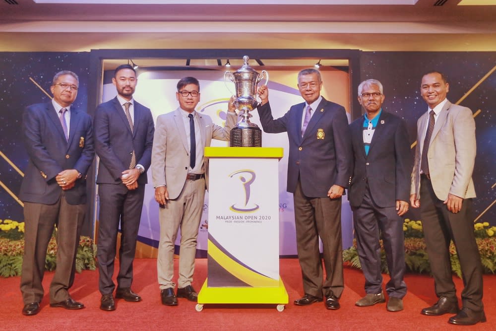 Malaysian Golf Association President Tan Sri Mohd Anwar Mohd Nor and Kota Permai Golf and Country Club Direct of Club Operations, Township and Property Management Tang Meng Loon lift the trophy together with partners after the ceremony December 16, 2019. — Picture by Ahmad Zamzahuri