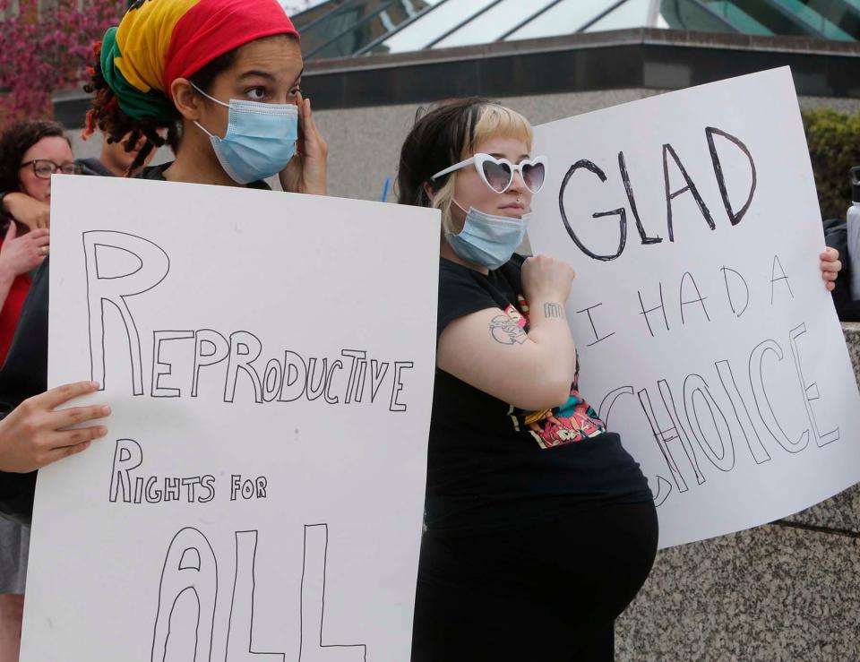 eMJay Al Barr, 17, left, wipes away tears as she and her friend June Pearce, 20, who is pregnant, participate in the "Bans Off Our Bodies Rally -- Abortion Rights are Human Rights" in front of the Federal Building in downtown Akron on Tuesday in reaction to the leaked Supreme Court decision on Roe V. Wade.