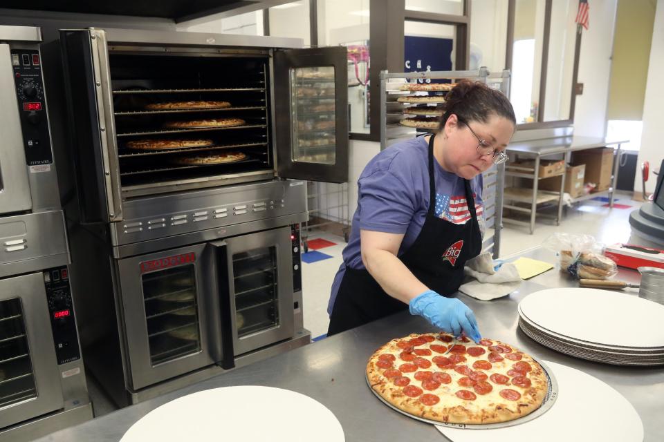 Machell McCain, who works in food services for the South-Western City School District, checks the internal temperature of a pizza prepared for students during a lunch period Jan. 19 at Grove City High School.