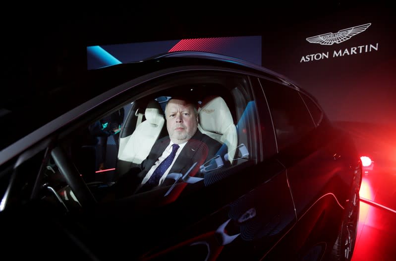 CEO of Aston Martin Andy Palmer poses for a photo inside the company's first sport utility vehicle Aston Martin DBX in Beijing