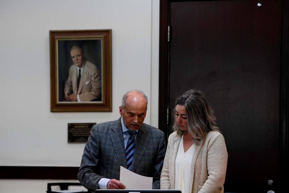 Defense attorney Peter Strianse shows RaDonda Vaught the documents to wave her right to testify during the third day of testimonies in the Vaught trial, at Justice A.A. Birch Building in Nashville , Tenn., Thursday, March 24, 2022. Vaught is a former Vanderbilt University Medical Center nurse who was charged in the death of a patient. 