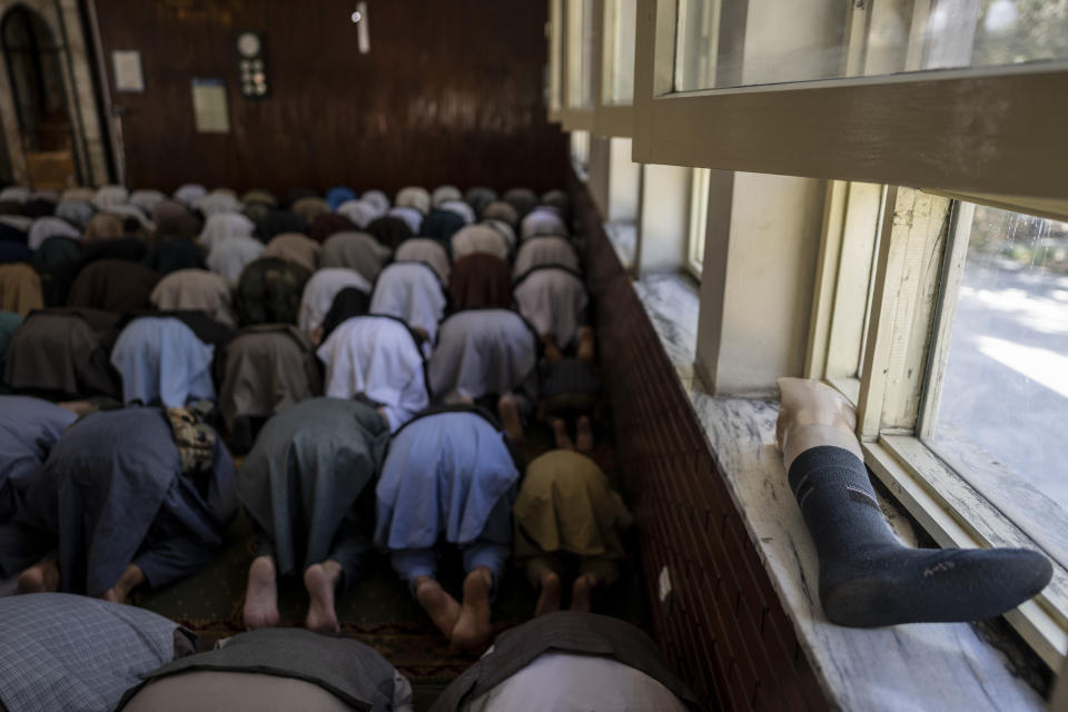 A prosthetic leg lays in a window frame during Friday prayers at a mosque in Kabul, Afghanistan, Friday, Sept. 17, 2021. (AP Photo/Bernat Armangue)