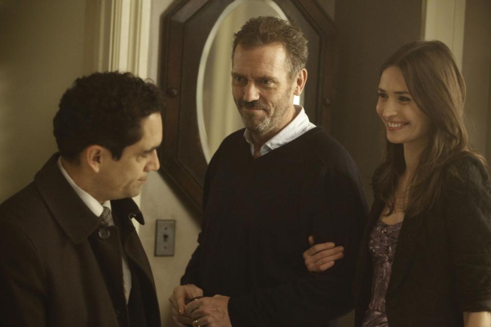 In this image released by Fox, Hugh Laurie portrays Dr. Gregory House, center, Karolina Wydra portrays Dominika, right, and Jose Zuniga portrays an immigration officer in a scene from "House, M.D." The Fox medical drama concludes its eight-season run on Monday, May 21, 2012, with a finale at 9 p.m. EDT, preceded by a one-hour retrospective. (AP Photo/Fox, Jordin Althaus)