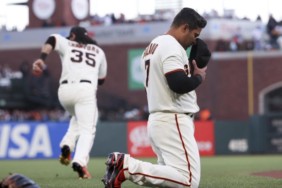 Giants' Donovan Solano prays on the field