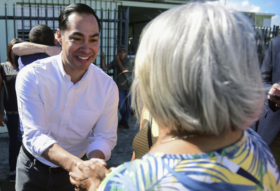 Julian Castro greets residents in Playita, one of the poorest and most affected communities in the aftermath of Hurricane Maria in San Juan, Puerto Rico, Monday Jan. 14, 2019. The U.S. presidential candidate has joined dozens of high-profile Latinos in Puerto Rico to talk about mobilizing voters ahead of the 2020 elections and increasing Latino political representation to take on President Donald Trump. (AP Photo/Carlos Giusti)