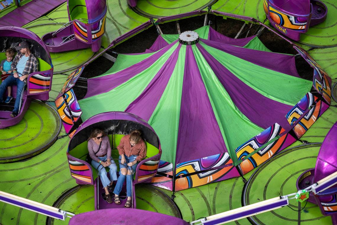 Fairgoers enjoy the Tilt-A-Whirl on the opening day of the 2022 North Carolina State Fair on Thursday, October 13, 2022 in Raleigh, N.C.