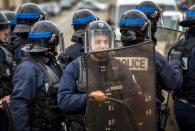 French police officers survey supporters of the Pegida movement (Patriotic Europeans Against the Islamisation of the Occident) gathered for a banned demonstration in Calais, northern France, on February 6, 2016