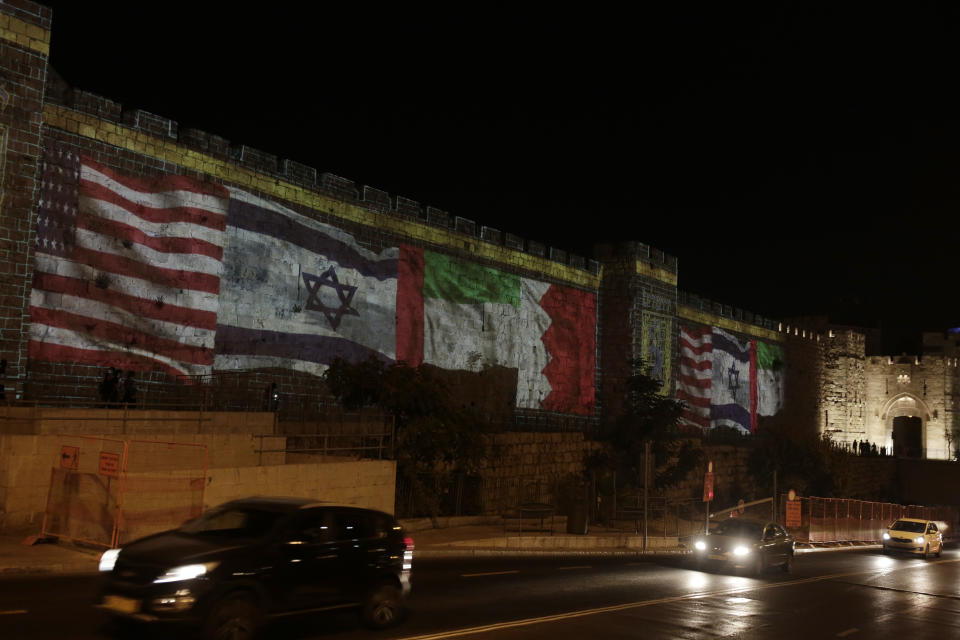 Representations of the U.S., Israeli, Emirati and Bahraini flags are projected onto a wall of Jerusalem's Old City, marking the day of a signing ceremony in Washington signifying the two Gulf nations' normalization of relations with Israel, Tuesday, Sept. 15, 2020. (AP Photo/Maya Alleruzzo)