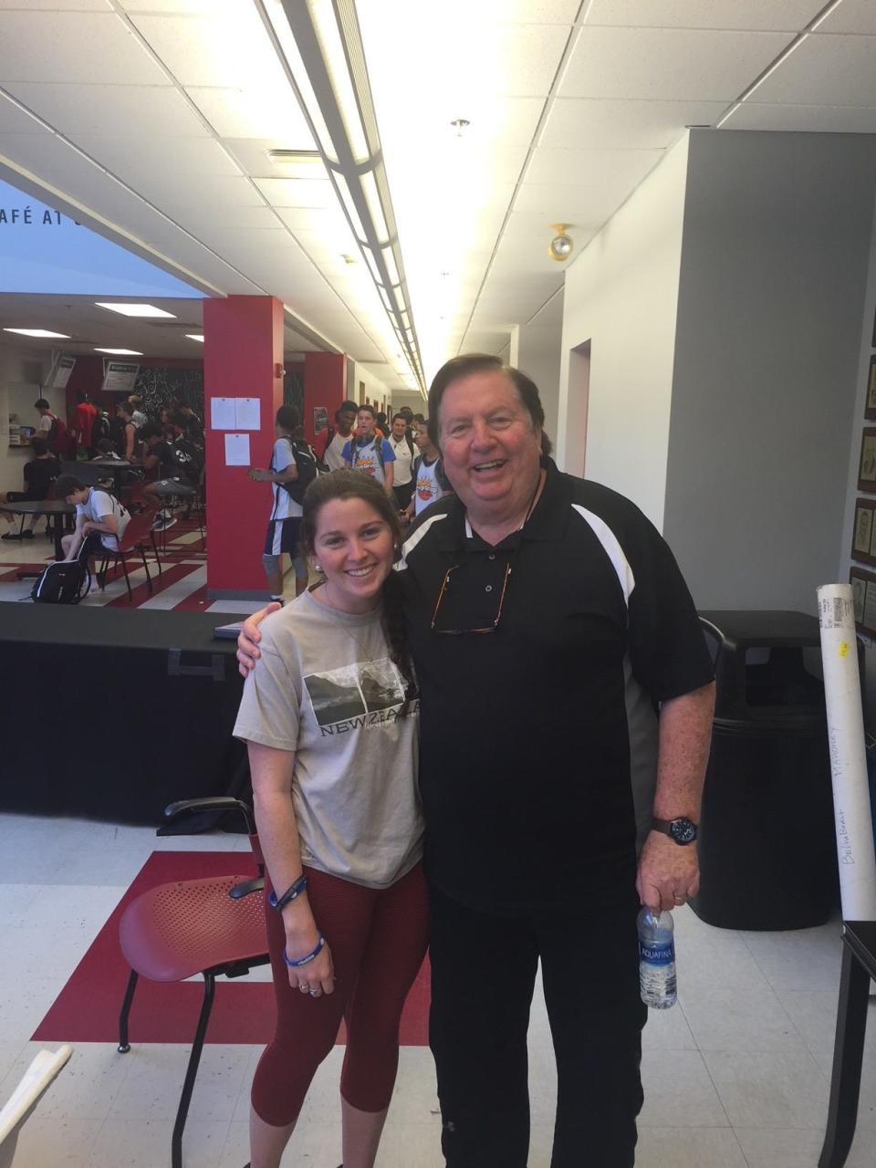 Pat Kennedy with a camper at a recent basketball camp.