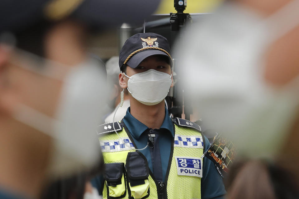 Police officers wearing face masks to help protect against the spread of the new coronavirus stand guard near the Japanese embassy in Seoul, South Korea, Wednesday, July 1, 2020. (AP Photo/Ahn Young-joon)