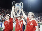 FILE - In this May 30, 1979 file photo Nottingham Forest's John Robertson, left, Ian Bowyer, center, and Kenny Burns, right, carry the European Cup in triumph after their 1-0 win against Malmo FF in Munich, Germany. N is for Nottingham Forest. Of all England's 13 wins Forest's consecutive triumphs in the 1979 and 1980 were the most unlikely. Only two-years before their win in Munich, Forest were playing in England's second tier, but their meteoric rise under the leadership of maverick boss Brian Clough is the stuff legends are made of. (AP Photo, File)