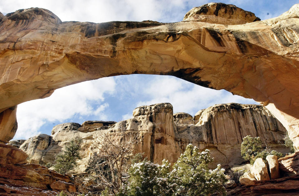 This undated photo, shows Hickman Arch at Capitol Reef near Torrey, Utah. As the coronavirus pandemic continues, the National Park Service is testing public access at several parks across the nation, including two in Utah, with limited offerings and services. (Danny Chan La/The Salt Lake Tribune via AP, File).