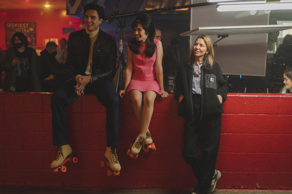 This image released by A24 shows Jacob Elordi, from left, Cailee Spaeny, and Sophia Coppola on the set of "Priscilla." (Sabrina Lantos/A24 via AP)