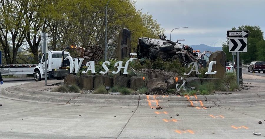 A car left a Washougal, WA roundabout crashing through a sign and landing on its side (KOIN)