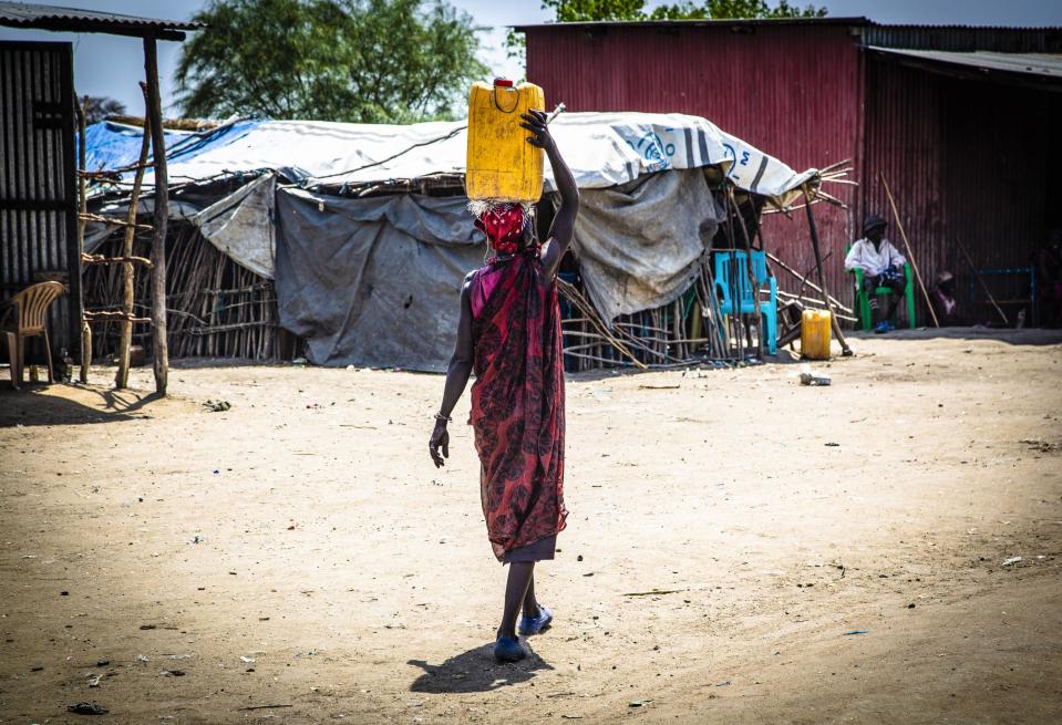 For a split second it looked like the young South Sudanese woman and her baby, swaddled in a cloth-carrier on her back, were taking a breather from the heat of the day under a tree.But then Mary, 25, a mother herself, took a second look. The two motionless figures were awkwardly propped up against the trunk. The bodies were stiff. Both had died from dehydration.This is Boma, a state in South Sudan that is suffering from one of the country’s worst water shortages.The world’s youngest country has been ravaged by a brutal five-year civil war that has killed over 400,000 people and pushed its population to the brink of famine. That conflict nominally ended in September, with South Sudan’s president, Salva Kiir Mayardit, and the rebel group led by Riek Machar signing a historic peace deal.But six months on, a simmering humanitarian crisis is threatening to unpick the tense truce.And water, though often ignored, is now at the heart of a new wave of unrest.Nearly 80 per cent of the country has no access to clean water, according to the government water authority, which said vital infrastructure has been destroyed in the fighting.With climate change driving up temperatures, water resources for cattle and agriculture are also in dwindling supply.The shortages have sparked armed conflicts between several of the country’s 60 or so ethnic groups and could be the tinder box for fresh conflict in the future, officials have warned.Caught in the crossfire are women, who are responsible for fetching water supplies even if it means making long and dangerous journeys.Mary says she found the bodies along the dirt track that leads to a water pump from Gumuruq, a remote village only accessible by helicopter and a long drive on dirt track roads.In this area, dozens of bore holes were destroyed in the civil war and so it is a treacherous eight-hour hike to the nearest water pump.Along the way, women risk dying of thirst or hunger, as well as being attacked and even raped by men, who in the searing heat of the dry season ambush them for their jerry cans.This, aid agencies say, is not a unique phenomenon for South Sudan – across the world, women are often the water fetchers and face similar violence.Mary and five women who sit beside her all say they have been ambushed fetching water. One had been raped at gunpoint.“I personally know 10 people who have died from thirst in the last 12 months, at least three already this year,” she tells The Independent from a tukul, or mud-packed reed hut, in her village.“It is a common problem and it is going to get worse in the next few weeks, which is the peak of the dry season.”“We have all been attacked walking to the bore holes. Water is scarce and the dry seasons are getting longer. This year we expect the number of deaths and attacks to be even higher.”South Sudan is limping through one of the world’s most severe humanitarian crises. Four million people have been displaced internally or externally, while more than two-thirds of the country, or 7.1 million, rely on aid to survive.Last month, the United Nations said that 1.5 million were on brink of starvation, and tens of thousands are already in famine.Despite the peace deal, battles still rage in southern regions between the army and a rebel force that refused to sign the September deal.Even the signatories to the agreement are wary of each other. The deal set a deadline for all sides to screen their respective forces and unify them into a national army before the formation of a unity government in May.None of these steps have been completed yet.But amid the mesmerising overlap of woes, water should not be an issue.Officials in South Sudan’s water authority say there is more than enough water to serve the population of just 10 million.The country is blighted by floods for more than half of the year and is crisscrossed with rivers, including the White Nile, one of the two main tributaries to the Nile. It also straddles three transboundary aquifers.And yet according to Oxfam, which runs several water, sanitation and hygiene programmes (WASH), around 6 million people, or three-quarters of the population, are in need of help getting access to clean water and sanitation.Millions are at risk of waterborne diseases such as typhoid and cholera, which spread unchecked in rural communities that lack access to basic sanitation.Armed groups have deliberately targeted water infrastructure during the years of fighting as a way of destroying the communities of their enemies. There are scant resources to rebuild these water holes: Oxfam and others say their WASH programmes are woefully underfunded. While Alier Ngongoka, the water authority chair, said only 0.1 per cent of the government budget is allocated for water. Ratcheting up pressure is climate change. Seasonal rivers are drying up early, forcing people such as those in cattle herding communities to be on the move, sparking mini local wars which the water authorities fear could bleed into the national conflict. Cattle raids and related child abductions are on the rise.Four million people have already been internally or externally displaced from the five-year civil war. But Ngongoka warned that if nothing was done to improve the water crisis, within two years there could be millions more on the move.Rural communities would be forced to move to urban areas, piling pressure on scant resources at a time when South Sudanese refugees are also beginning to return to the country.“Water creates real armed conflicts among the pastoral communities, particularly as the dry season is getting longer,” Ngongoka tells The Independent from his office in the capital Juba. “We have already seen fighting in areas like greater Jonglei, Akobo and eastern Equatoria.” He adds: “With no support to our WASH activities to help communities access water we will see more conflict, particularly with the impact of climate change.”Compounding the problem is the fact that as South Sudan has no storage facilities to collect and store water, there is also no data to ascertain the real size of the crisis.And that is why the government is hoping to build a large dam on the White Nile just south of Juba, to also produce clean energy.> Every year the violence is getting worse because access to water is deterioratingBoma governor John JosephBut that is a controversial decision. Egypt and Ethiopia, both Nile Basin countries, have nearly come to blows over the Grand Ethiopian Renaissance Dam (GERD) on the other main tributary: the Blue Nile.Egypt’s population heavily relies on the Nile and so Cairo is terrified that Ethiopia’s dam, the largest hydropower plant in Africa, will drastically reduce water flow downstream and impact its national security.The decade-long spat has yet to be resolved. Egypt has talked about the GERD being a “national security issue”.A dam in South Sudan, on the other Nile source, could spark an international conflict if not carefully handled.But for now the authorities are more concerned about domestic conflict and violence.In Pibor, the regional capital of Boma where Mary is from, local governor John Joseph warns that people have already died in his state over water.“As the government, we don’t have the capacity to build permanent water infrastructure for people or livestock,” he says. “Every year the violence is getting worse because access to water is deteriorating.”Opposite his battered offices, across a dirt-track compound, local gender minister Lydia Agolory keeps a watchful eye over a toddler boy and a girl, who is barely five years old.The children were abducted from their families in 2017 by cattle raiders but were only recently found.Child abduction has become a business in the region as kidnappers are able to take children during raids and sell them for livestock to families who are unable to conceive.But bizarrely the local authorities have linked the spike in abductions to the water crisis. Cattle raids are increasing as shepherding communities are on the move looking for water resources or new livestock to replace those lost to thirst, leading to direct conflict with rival ethnic groups.One of the main side businesses is taking children along with the cows.These two children were too little when they were abducted to know their real parents, names or home towns and so are upset and confused.Agolory explains it is too dangerous to keep the pair in Pibor, as they are at risk of being rekidnapped by the disgruntled family who paid 30 cattle for each of them. The children are put, sobbing, on a tiny propeller plane bound for the capital.“In so many ways, women and children are worst impacted by the water crisis,” she adds.Back in Gumuruq, Mary shows where the scars stutter across her arms and legs from when she was attacked by armed men while fetching water last year.> Two men demanded we lie down on our faces, they told me they would kill us if we didn’t do what they saidMother-of-three Elizabeth, in the village of GumuruqThey flogged her so hard with sticks she was carried to a field clinic unconscious.She then spent 10 months in hospital recovering and was only recently discharged. “Since that time until now I am now too weak to get water,” she says.“I still feel pain every day,” she adds, before trailing off.Elizabeth, 35, who sits beside her, says she was raped at gunpoint in February 2016 by a gang of men who, she says, hide in the bush preying on women fetching water and firewood.“Two men demanded we lie down on our faces, they told me they would kill us if we didn’t do what they said,” the mother-of-three explains.“I had no power and had to surrender myself to him,” she adds.But the situation is even worse in Manyabol, a two-hour drive from Gumuruq, along a recently cleared dirt track. The village is so remote the commissioner of the area makes a point of repeatedly saying we are the first white people to set foot there.Scrambling through the bush, heavy with birdsong, villagers from the Murle ethnic group that live there point out the water pumps that were destroyed in the fighting a few years ago.Members of the Dinka in Bor, a neighbouring but rival ethnic group who took an opposing side in the civil conflict, had bulldozed all the water pumps in the area with armed vehicles to devastate the local community, according to local officials.With resources stretched to breaking point, no aid organisation has been able to make it this far to repair the damage.That day, a team from Oxfam were visiting the area to assess the damage.“It was a deliberate attack to try to destroy the town, where 2,000 people live,” says loca commissioner Jacob Labousho. “But we hope now there is peace agreement, we can move on from this and get assistance to rebuild. “No aid organisations come this far but with the seasonal rivers drying up early we have no access to water.”Marconi Kuju, a member of the Oxfam team, says 100 water pumps were destroyed in that area alone, forcing women to walk up to 10 hours for water.“It is an issue of money, there is a big funding gap for WASH programmes because it doesn’t attract the same level of attention as other crises,” he says.Oxfam has only received funding to build two new bore holes this year. Their teams were busy drilling one, about four hours away near the capital Pibor. It’s a race against time: the water level is dropping each year, meaning they have to dig even deeper, making the drilling process more expensive.At one pump rehabilitated by the aid organisation last year, a line of women, who have walked for hours, start the laborious process of pumping water into dozens of jerry cans. It is exhausting work. In the searing heat they take turns to throw their full body weight on the metal lever to fill the canary-yellow containers.As the pressure mounts, a fight breaks out. Only two of the six pumps in this area are working, which is causing problems because the population is booming.“The water levels are too low so it’s hard to pump – it can take an hour to fill a single jerry can,“ Nachunalan, 43, says, taking a breather by a patch of reeds.“There has been no change for us since the peace deal was signed. Women are facing thirst, hunger, and violence. When will it end?”Read the next five parts of the Water Waters series, Boiling Basra, Iraq’s disappearing Eden, Drought drove people into the arms of Isis​, How a water crisis in Jordan could threaten Middle East peace​ and Ticking time bomb