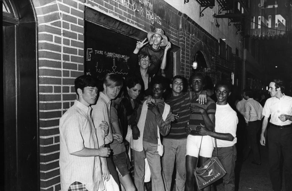 Young people celebrate outside the boarded-up Stonewall Inn at 53 Christopher Street after riots over the weekend of June 27, 1969. (Photo: Fred W. McDarrah/Getty Images)