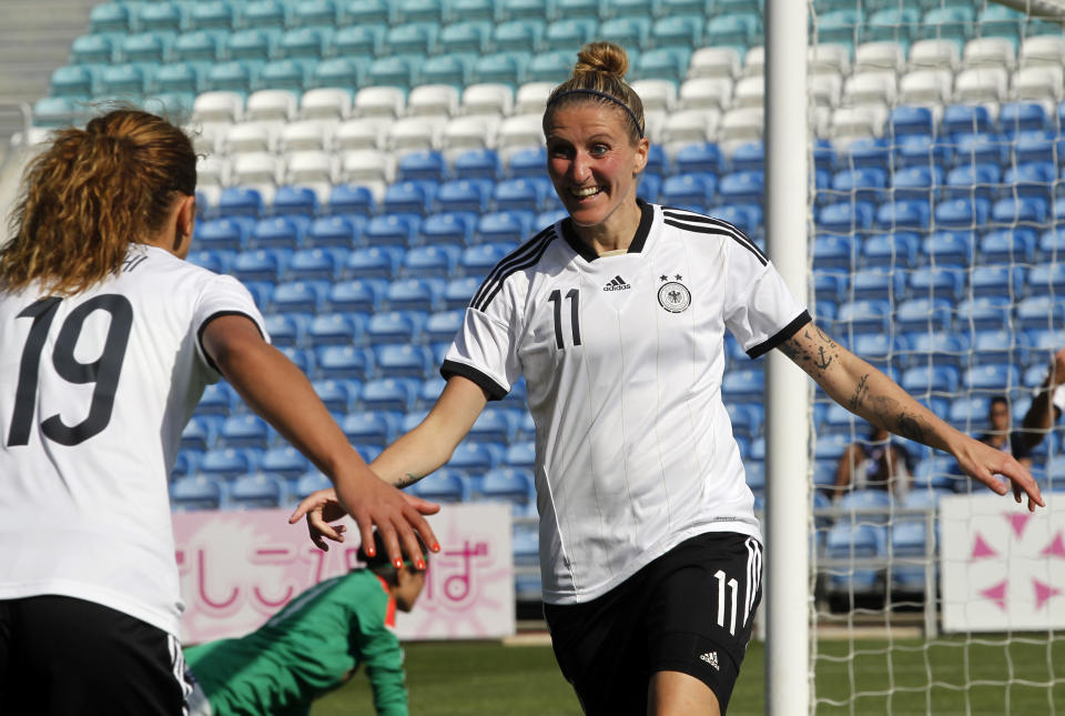 Germany's Anja Mittag, right, celebrates with teammate Fatmire Alushi after scoring their side's second goal during the women's soccer Algarve Cup final match between Germany and Japan at the Algarve stadium, outside Faro, southern Portugal, Wednesday, March 12, 2014. (AP Photo/Francisco Seco)