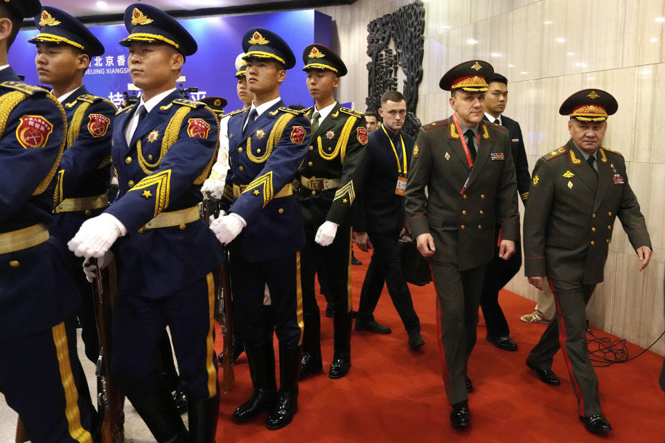 Russian Defense Minister Sergei Shoigu, right, walks past a Chinese honor guard as he arrives for the 10th Beijing Xiangshan Forum in Beijing, Monday, Oct. 30, 2023. Defense Minister Shoigu said Monday the United States is fueling geopolitical tensions to uphold its "hegemony" and warned of the risk of confrontation between major countries. (AP Photo/Ng Han Guan)