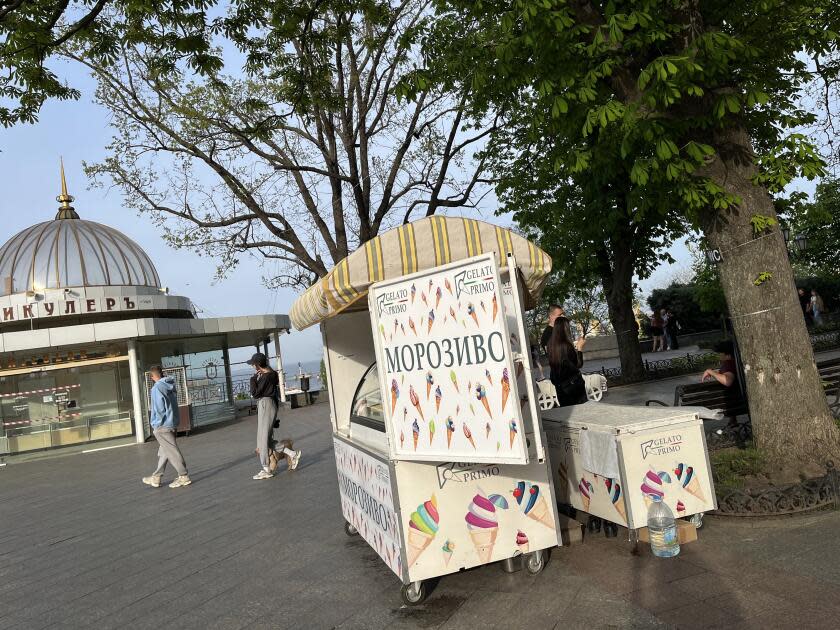An ice cream stand on a public promenade 