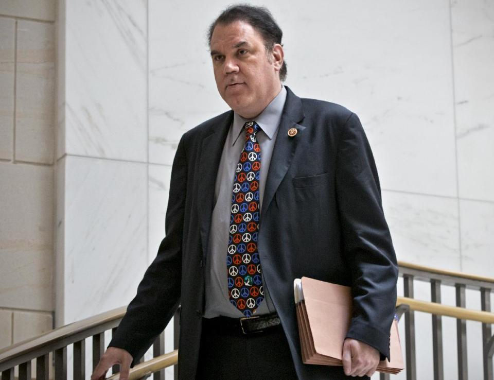 In this Sept. 5, 2013 file photo, Rep. Alan Grayson, R-Fla., arrives to join lawmakers and national security officials at the Capitol for a closed-door briefing on the situation in Syria, in Washington. Grayson issued a statement Wednesday, March 5, 2014 denying he battered his estranged wife. His wife, Lolita, claims he pushed her against the front door of their Orlando home when he stopped by the house to visit his children on Saturday, March 1, 2014. (AP Photo/J. Scott Applewhite, File)