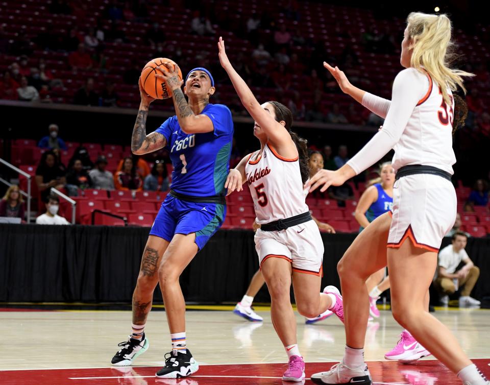 Florida Gulf Coast's Kierstan Bell (1) drives to the basket by Virginia Tech's Georgia Amoore (5) Friday, March 18, 2022, at University of Maryland Xfinity Center in College Park, Maryland.