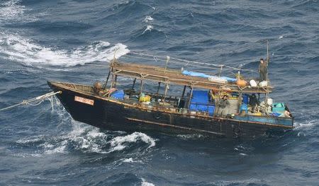 A wooden boat carrying men identified as North Koreans by coast guards drifts off Matsumae town, on Japanese northern island of Hokkaido, in this photo taken by Kyodo November 29, 2017. Mandatory credit Kyodo/via REUTERS